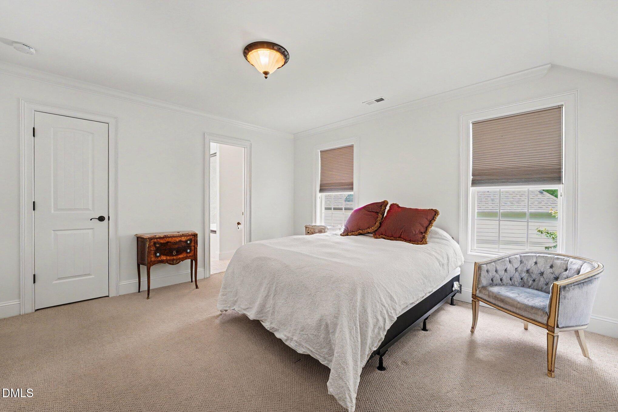 1729 Frenchwood Drive Raleigh, NC 27612 - Photo 24 of 46 a bedroom with a bed and a lamp
