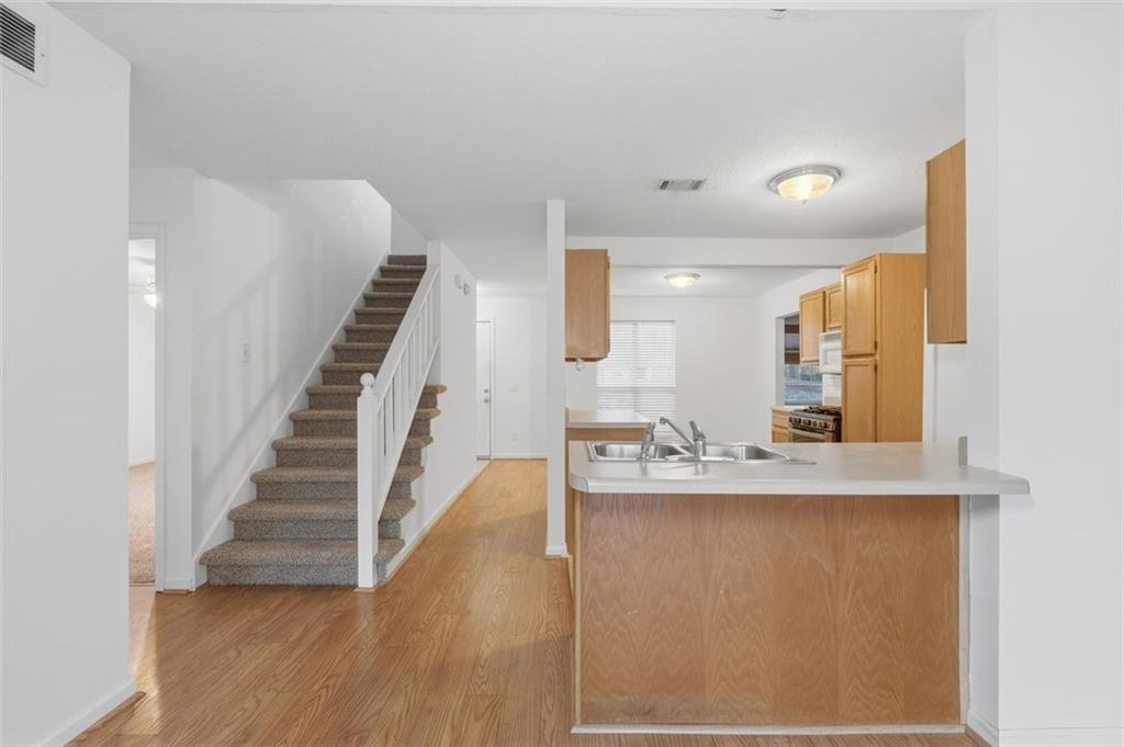 1032 Morgan Road Canton, GA 30115 - Photo 15 of 35 a view of a hallway with wooden floor and staircase