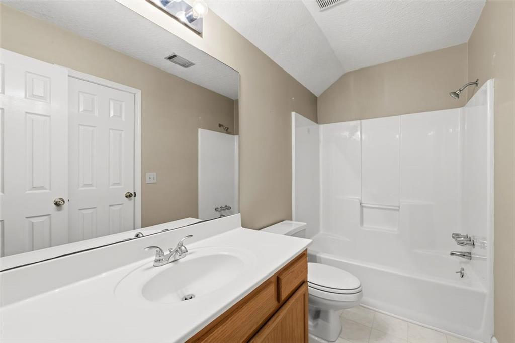 1032 Morgan Road Canton, GA 30115 - Photo 26 of 35 a bathroom with a sink a toilet and shower