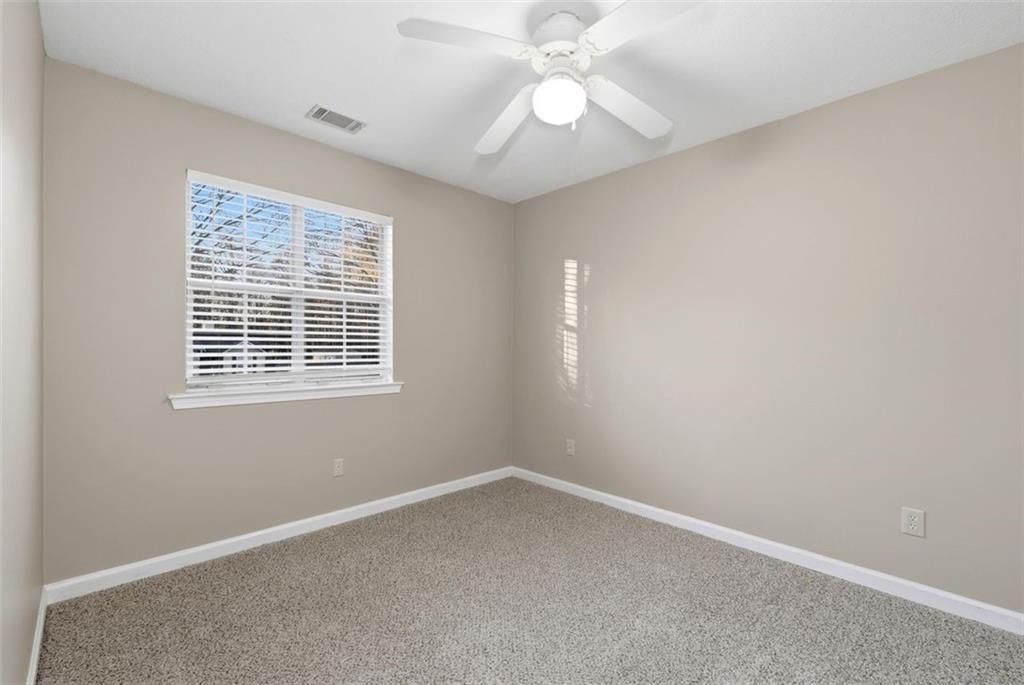 1032 Morgan Road Canton, GA 30115 - Photo 27 of 35 an empty room with windows and fan