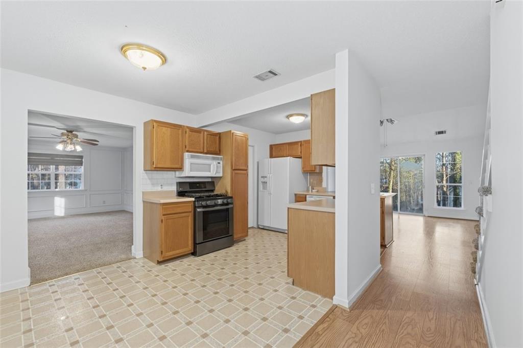 1032 Morgan Road Canton, GA 30115 - Photo 6 of 35 a kitchen with granite countertop a refrigerator and a stove top oven