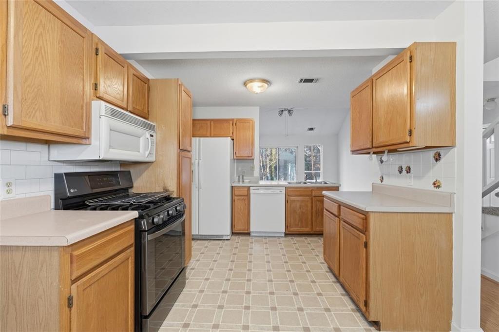 1032 Morgan Road Canton, GA 30115 - Photo 7 of 35 a kitchen with a sink cabinets stainless steel appliances and a window