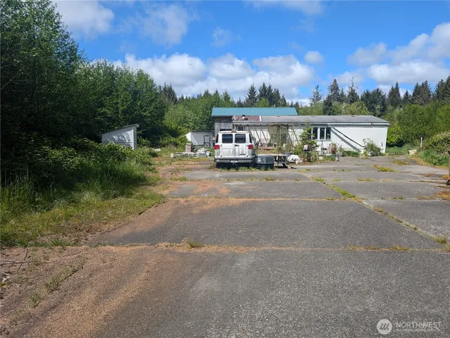 a view of a house with roof deck and car parked