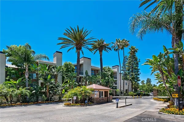 a view of multiple houses with palm trees