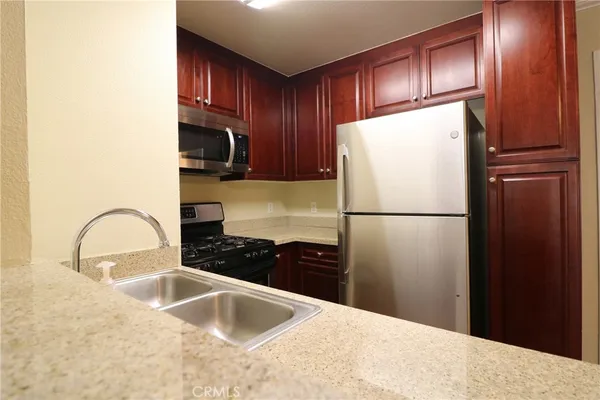 a kitchen with a refrigerator and a sink