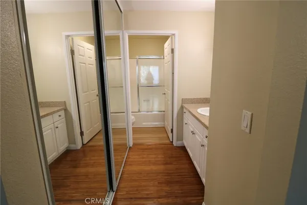 a bathroom with a double vanity sink and a large mirror