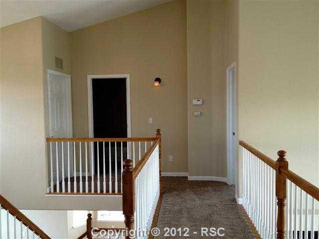 9428 Rockingham Drive Peyton, CO 80831 - Photo 13 of 17 upstairs bridge overlooking the entry and the great room