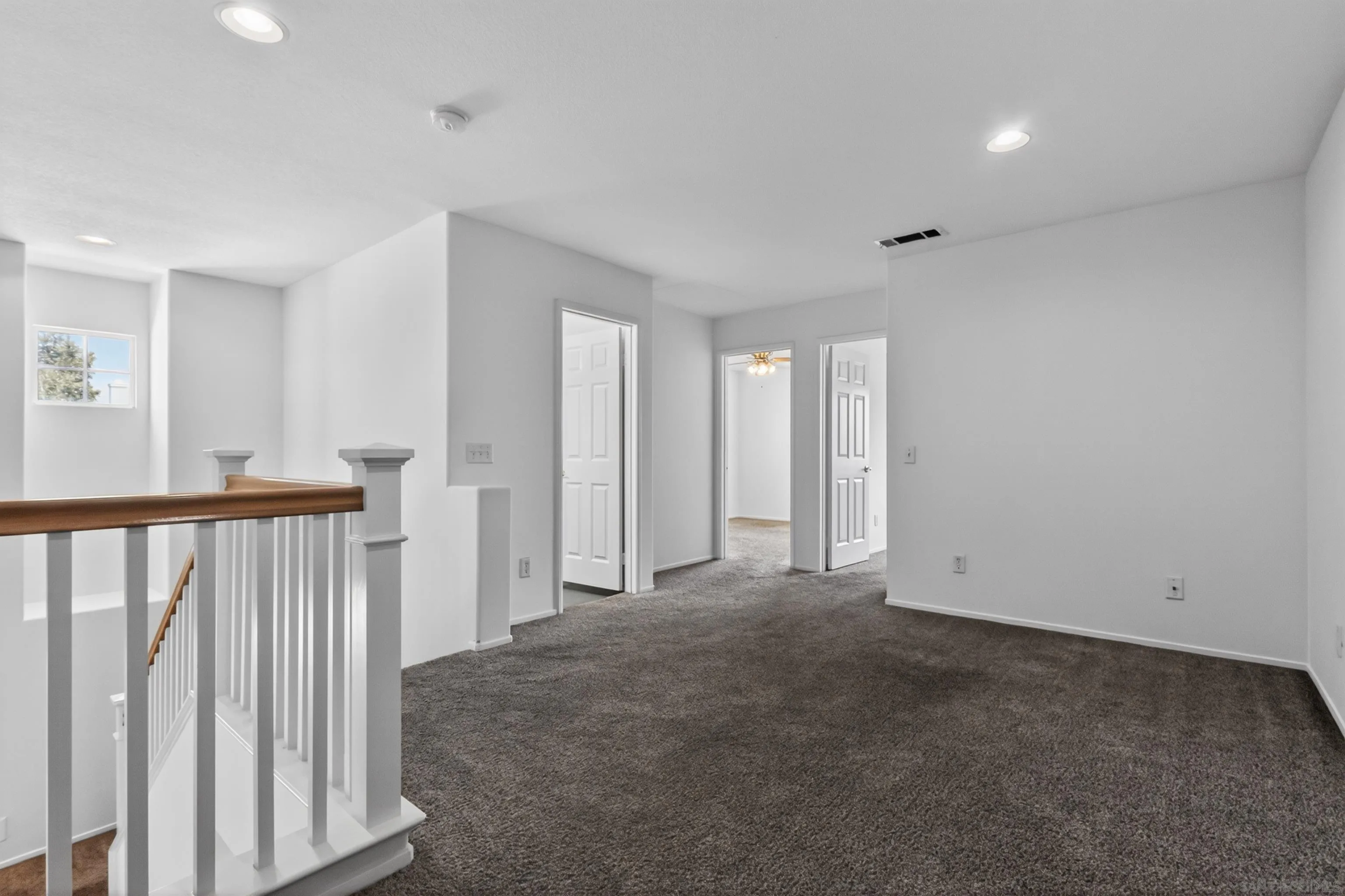1432 Belmont Park Road Oceanside, CA 92057 - Photo 46 of 54 a view of an empty room with wooden floor