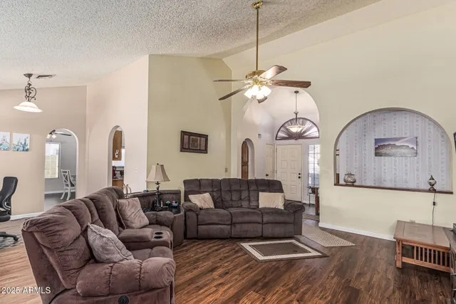 a living room with furniture a fireplace and wooden floor