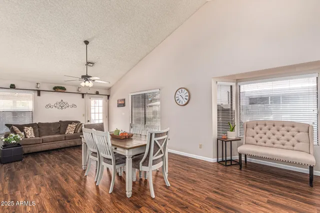 a dining room with furniture a chandelier and wooden floor