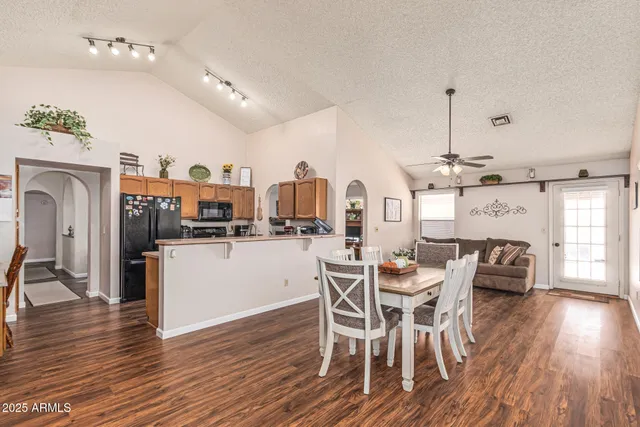 a dining room with furniture and wooden floor
