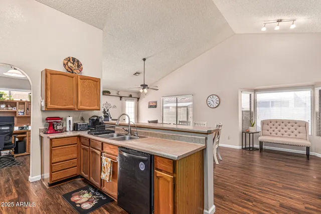 a kitchen with stainless steel appliances a sink a stove and a refrigerator