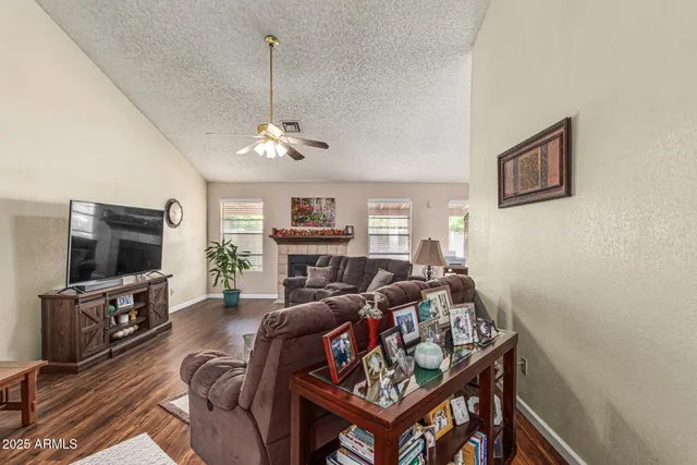 a living room with furniture a flat screen tv and a dining table