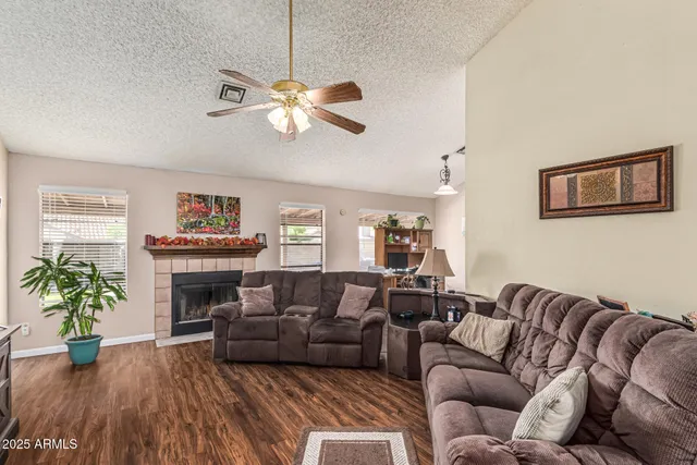 a living room with furniture a fireplace and a flat screen tv