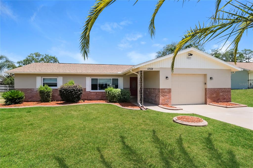 a front view of a house with a yard and garage