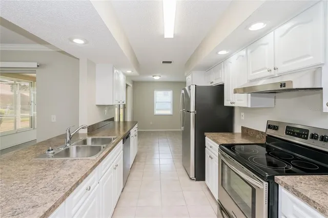 a kitchen with a sink stove and refrigerator