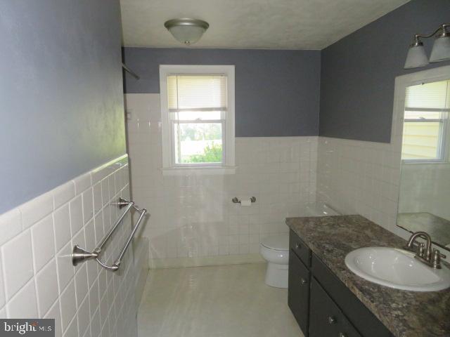 1240 Hoff Road Hanover, PA 17331 - Photo 15 of 51 a bathroom with a granite countertop sink toilet and a window