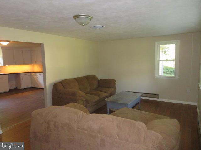 1240 Hoff Road Hanover, PA 17331 - Photo 10 of 51 a living room with couches and painted walls with a projector