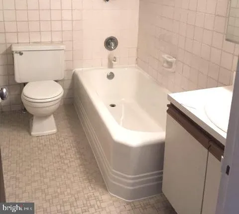 a utility room with multiple dryer and washer
