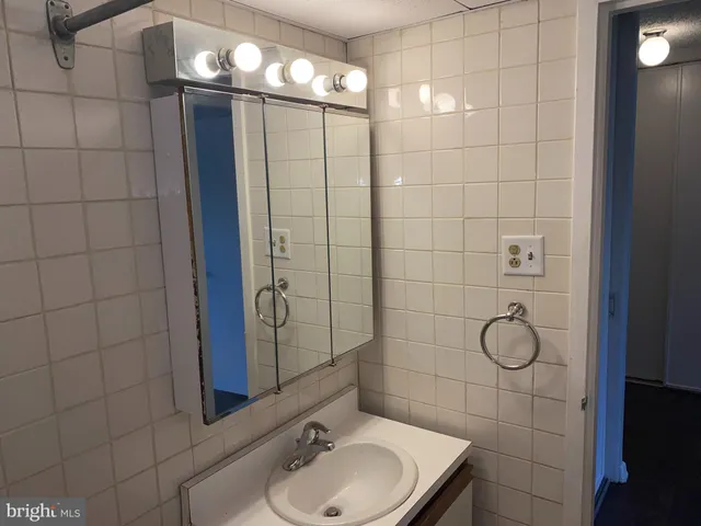 a view of a kitchen with furniture and washing machine