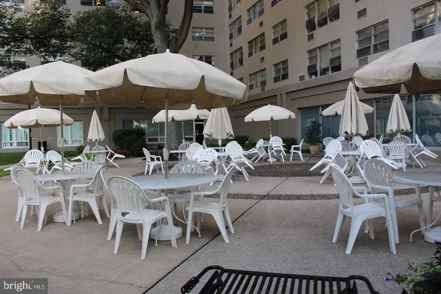 a view of backyard with swimming pool and seating