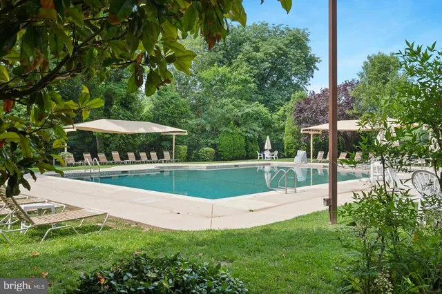 a view of a chair and table in backyard of the house