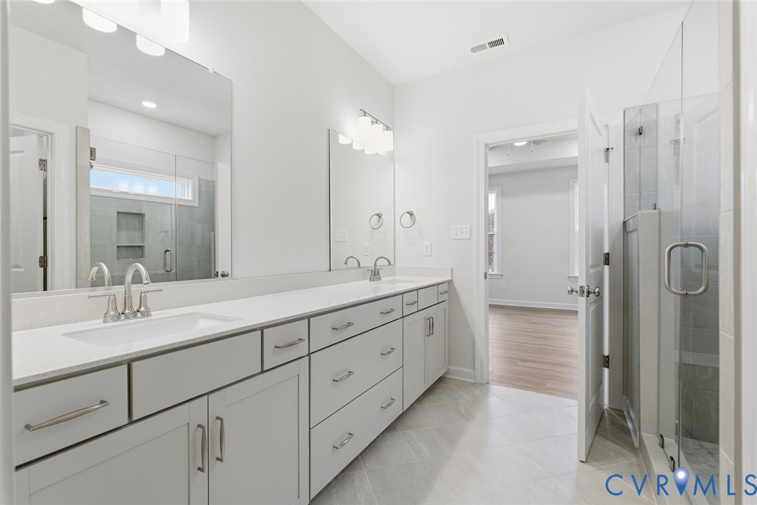 19018 Palisades Ridge Moseley, VA 23120 - Photo 11 of 37 a bathroom with double sink shower and two mirror