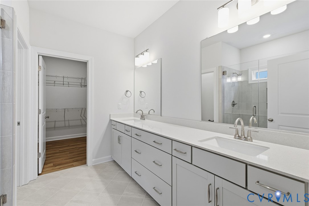19018 Palisades Ridge Moseley, VA 23120 - Photo 12 of 37 a en suite bathroom with double sink and a mirror