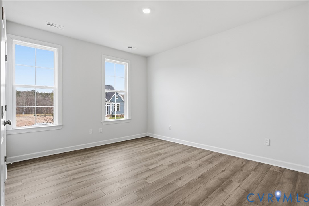 19018 Palisades Ridge Moseley, VA 23120 - Photo 17 of 37 an empty room with wooden floor and windows