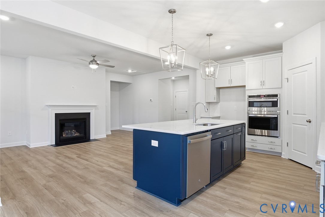 19018 Palisades Ridge Moseley, VA 23120 - Photo 2 of 37 a large kitchen with stainless steel appliances granite countertop a sink a stove and a wooden floors