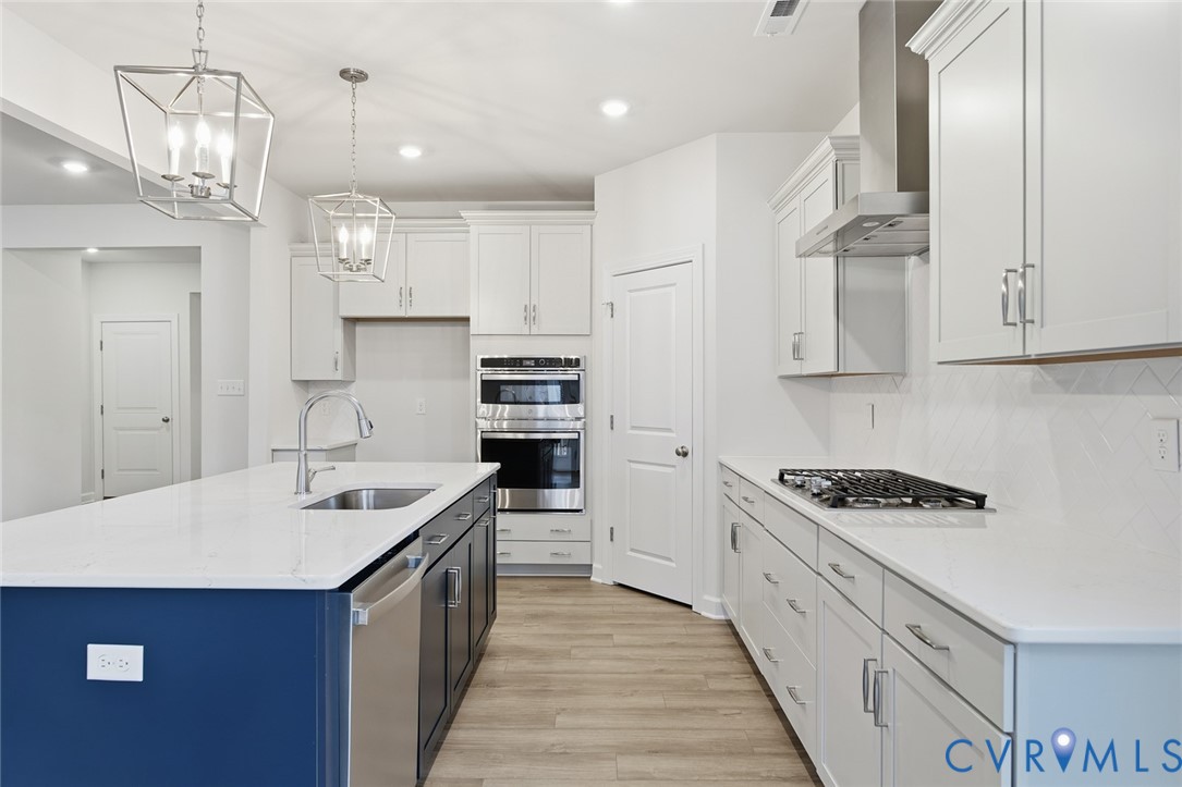 19018 Palisades Ridge Moseley, VA 23120 - Photo 7 of 37 a kitchen with stainless steel appliances granite countertop a sink stove and refrigerator