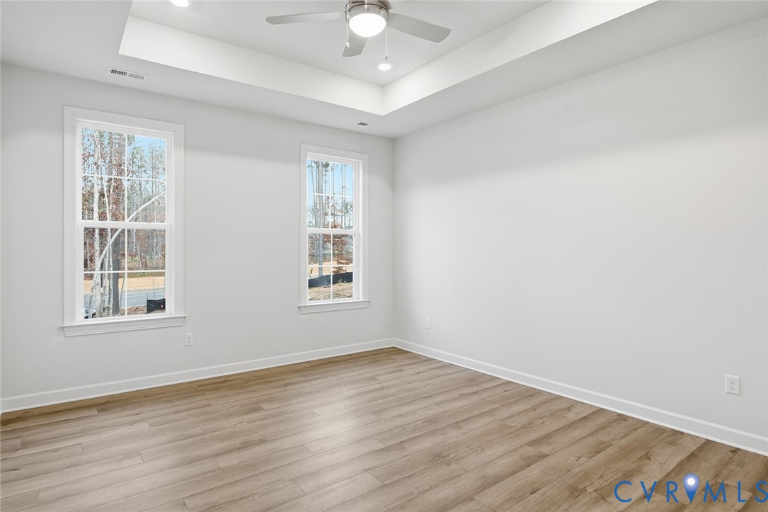 19018 Palisades Ridge Moseley, VA 23120 - Photo 8 of 37 an empty room with wooden floor chandelier fan and windows