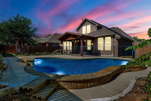 a front view of a house with swimming pool having outdoor seating