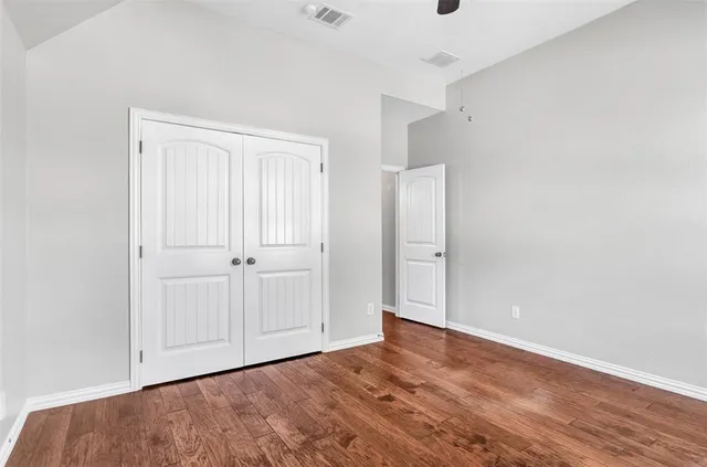 an empty room with wooden floor