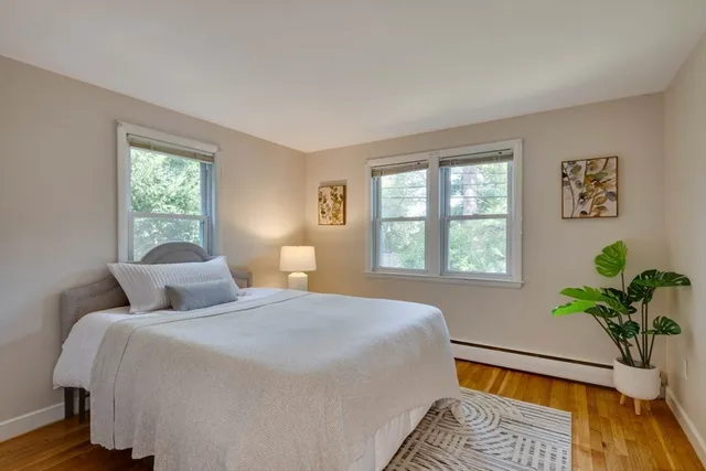 a bedroom with a bed running cycle and a window