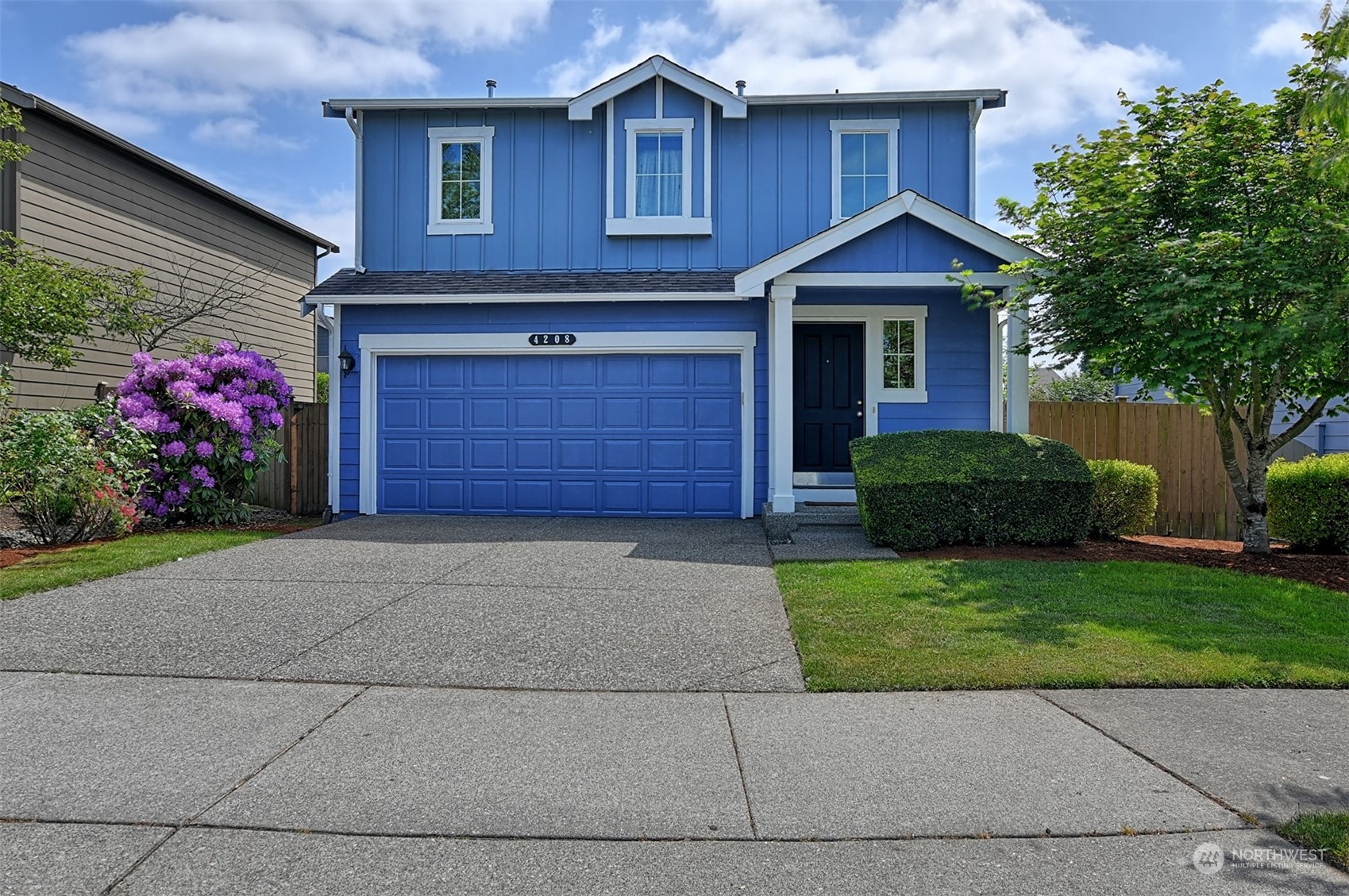 4208 166th Place Southeast Bothell, WA 98012 - Photo 1 of 1 a front view of a house with a garden