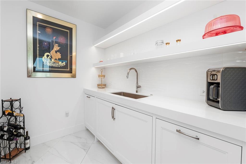 13945 Old Coast Road, Unit 806 Naples, FL 34110 - Photo 10 of 50 a kitchen with sink and refrigerator