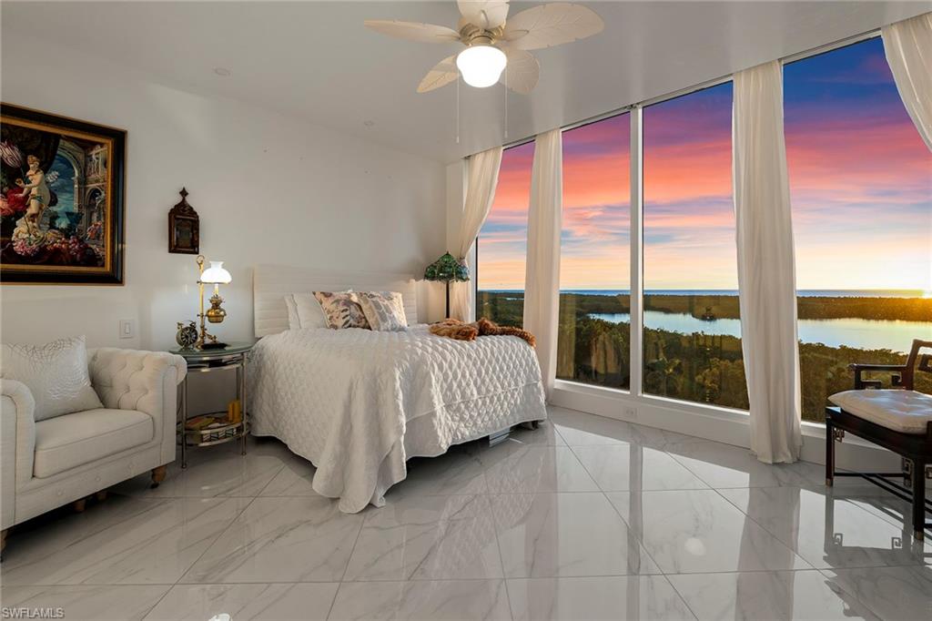 13945 Old Coast Road, Unit 806 Naples, FL 34110 - Photo 14 of 50 a bedroom with a bed and a large window