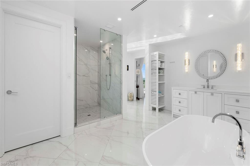 13945 Old Coast Road, Unit 806 Naples, FL 34110 - Photo 17 of 50 a bathroom with a sink a toilet and shower