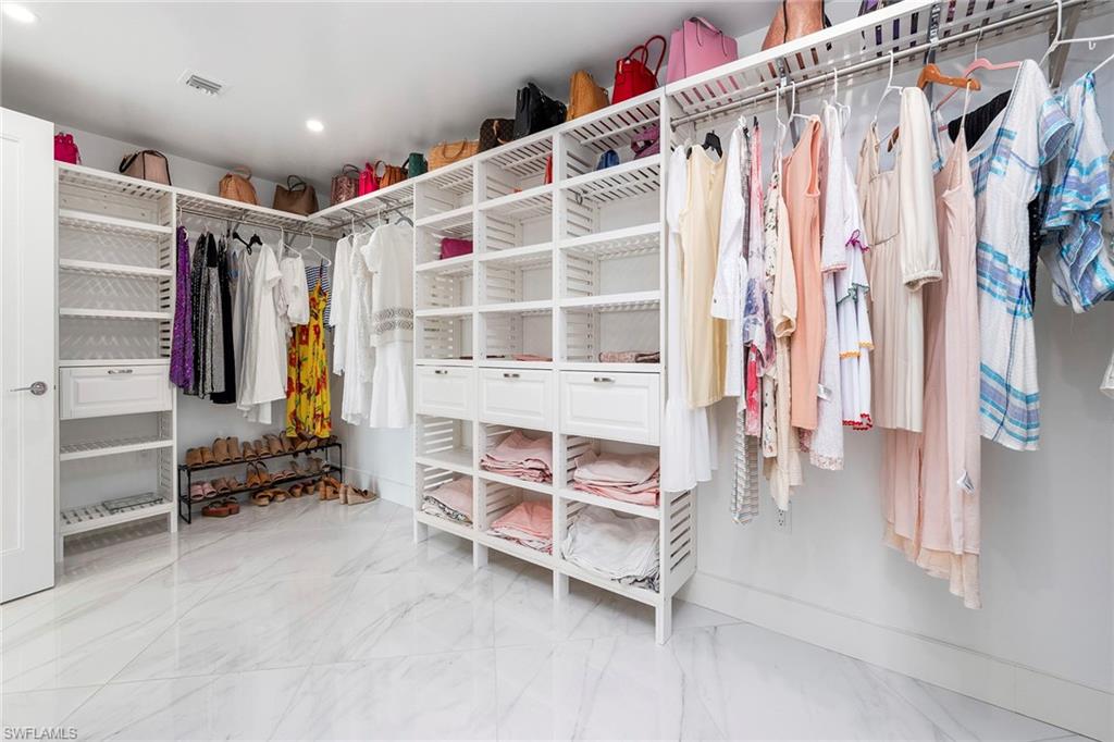 13945 Old Coast Road, Unit 806 Naples, FL 34110 - Photo 18 of 50 a view of walk in closet with clothes and shoes