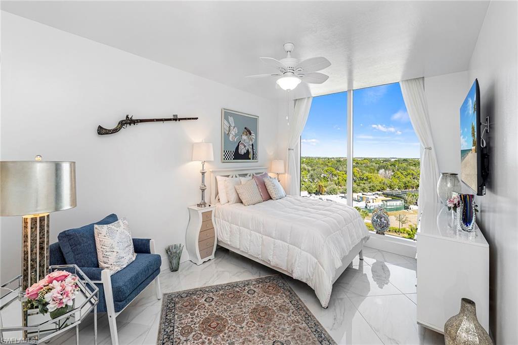 13945 Old Coast Road, Unit 806 Naples, FL 34110 - Photo 21 of 50 a bedroom with a bed and a flat screen tv