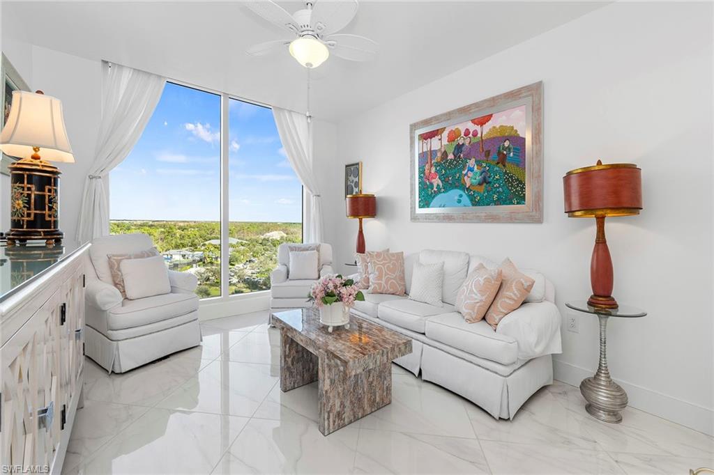 13945 Old Coast Road, Unit 806 Naples, FL 34110 - Photo 23 of 50 a living room with furniture and a large window