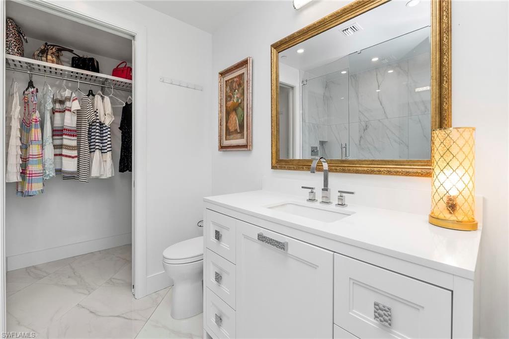 13945 Old Coast Road, Unit 806 Naples, FL 34110 - Photo 25 of 50 a bathroom with a sink a toilet and shower