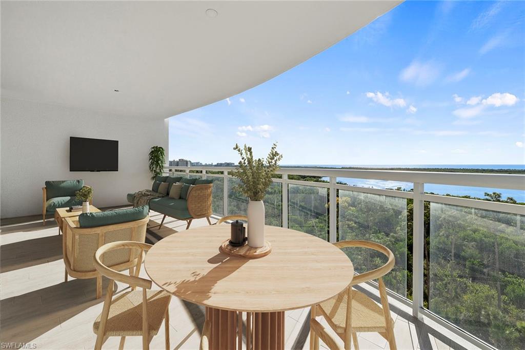 13945 Old Coast Road, Unit 806 Naples, FL 34110 - Photo 30 of 50 a view of a dining room with furniture and chandelier