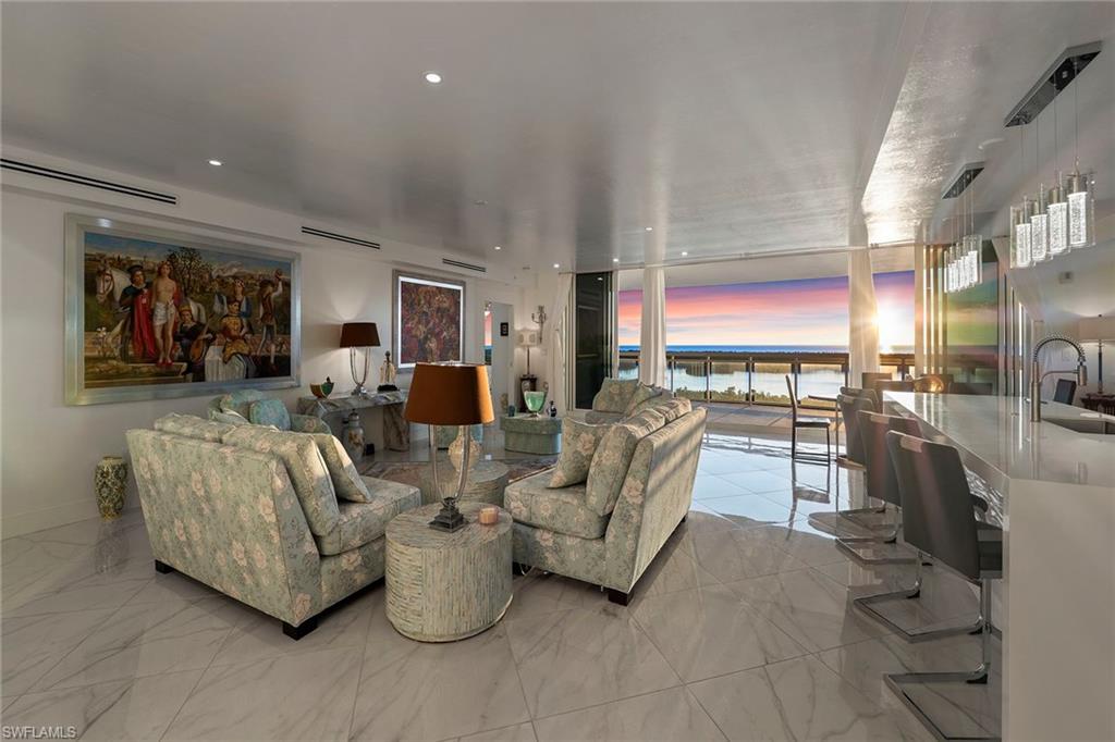 13945 Old Coast Road, Unit 806 Naples, FL 34110 - Photo 31 of 50 a living room with furniture and a flat screen tv