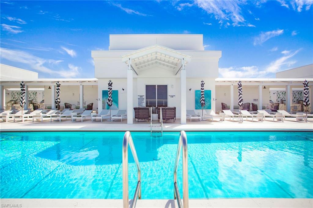 13945 Old Coast Road, Unit 806 Naples, FL 34110 - Photo 36 of 50 a view of a swimming pool and a chairs