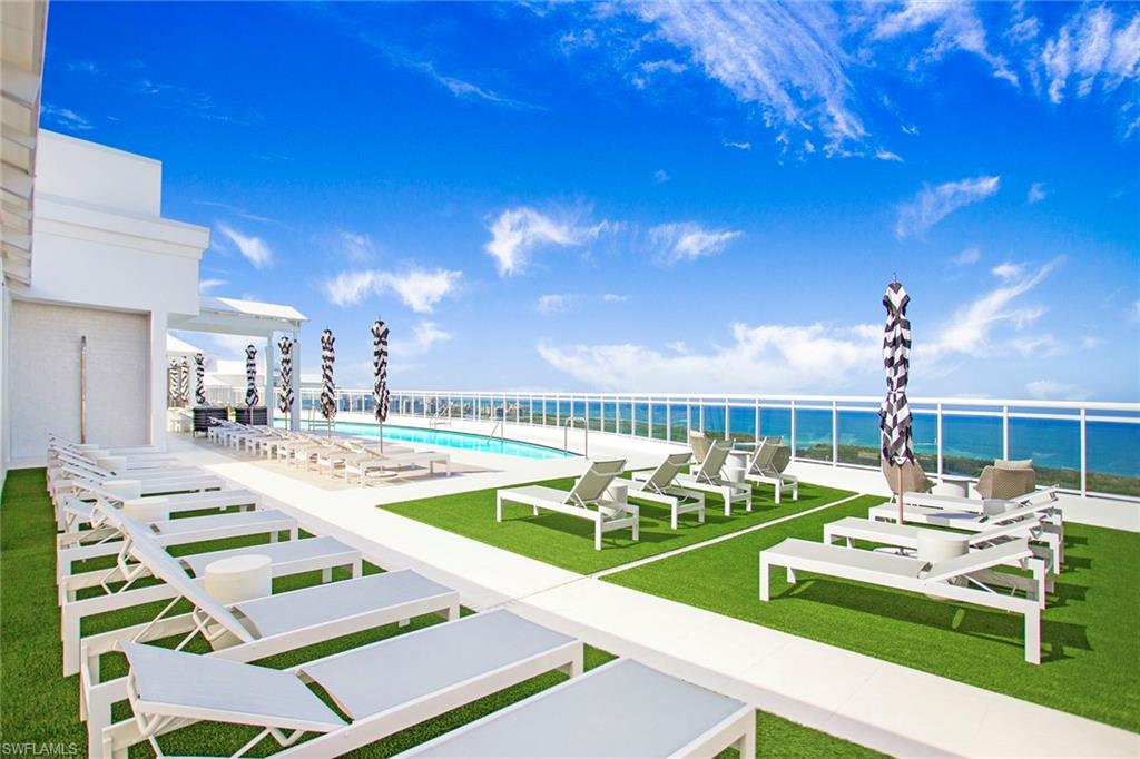 13945 Old Coast Road, Unit 806 Naples, FL 34110 - Photo 37 of 50 a view of a swimming pool and lounge chairs