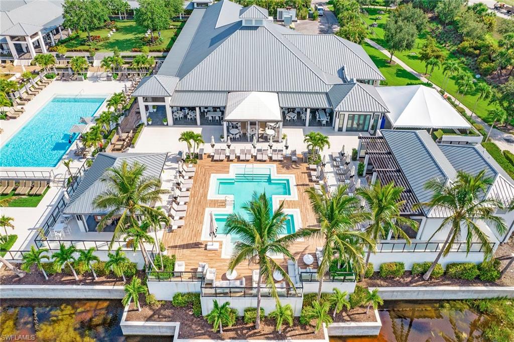 13945 Old Coast Road, Unit 806 Naples, FL 34110 - Photo 42 of 50 an outdoor space with plants and umbrella