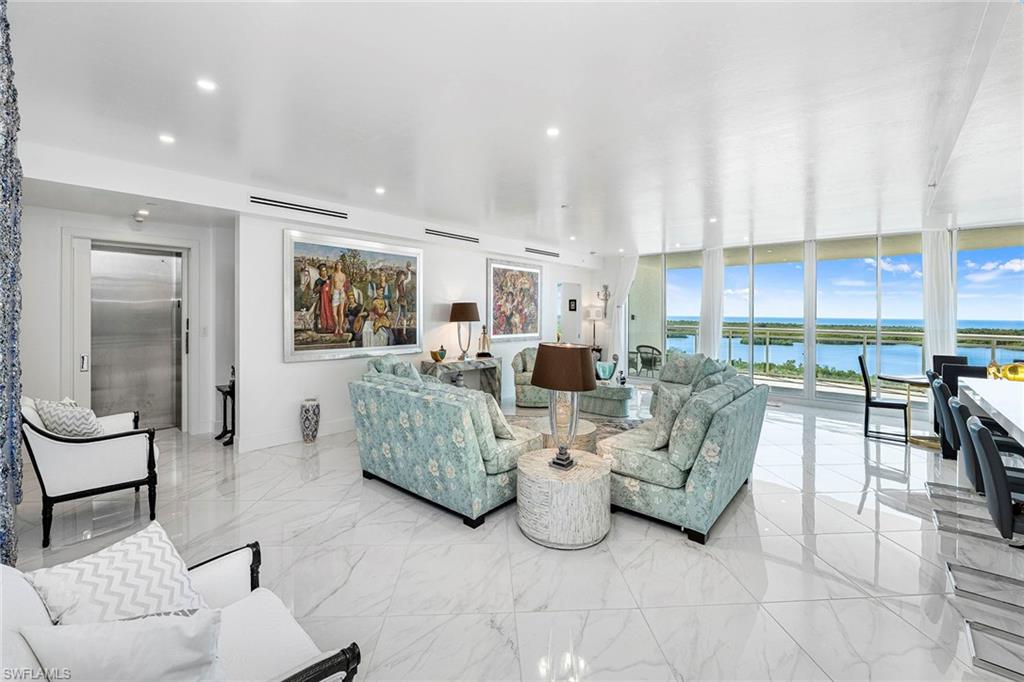 13945 Old Coast Road, Unit 806 Naples, FL 34110 - Photo 5 of 50 a living room with furniture and a large window