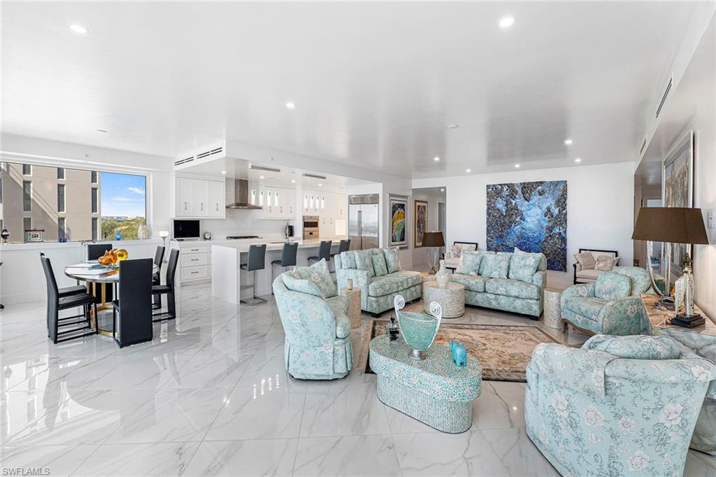 13945 Old Coast Road, Unit 806 Naples, FL 34110 - Photo 6 of 50 a living room with lots of furniture and kitchen view